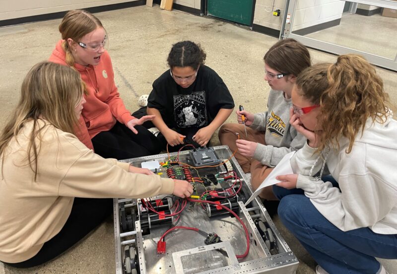 middle school students working on robot