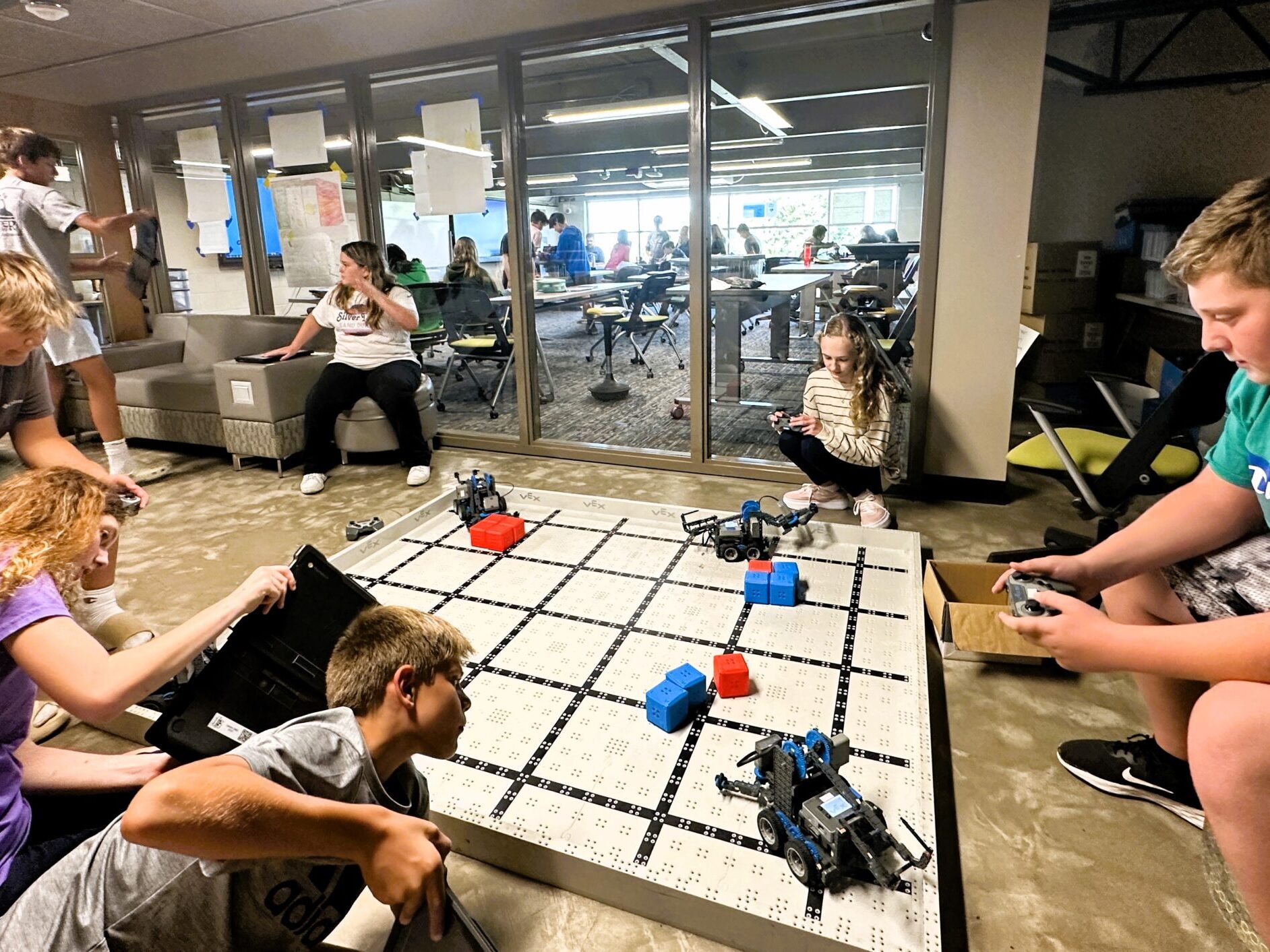 middle school students operating robots